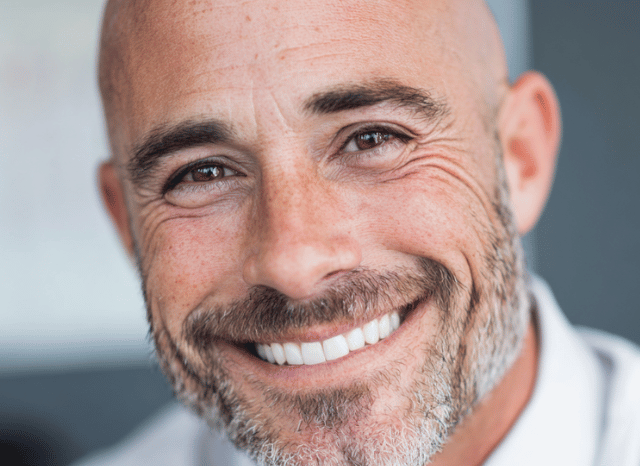 A visual representation of a smiling man